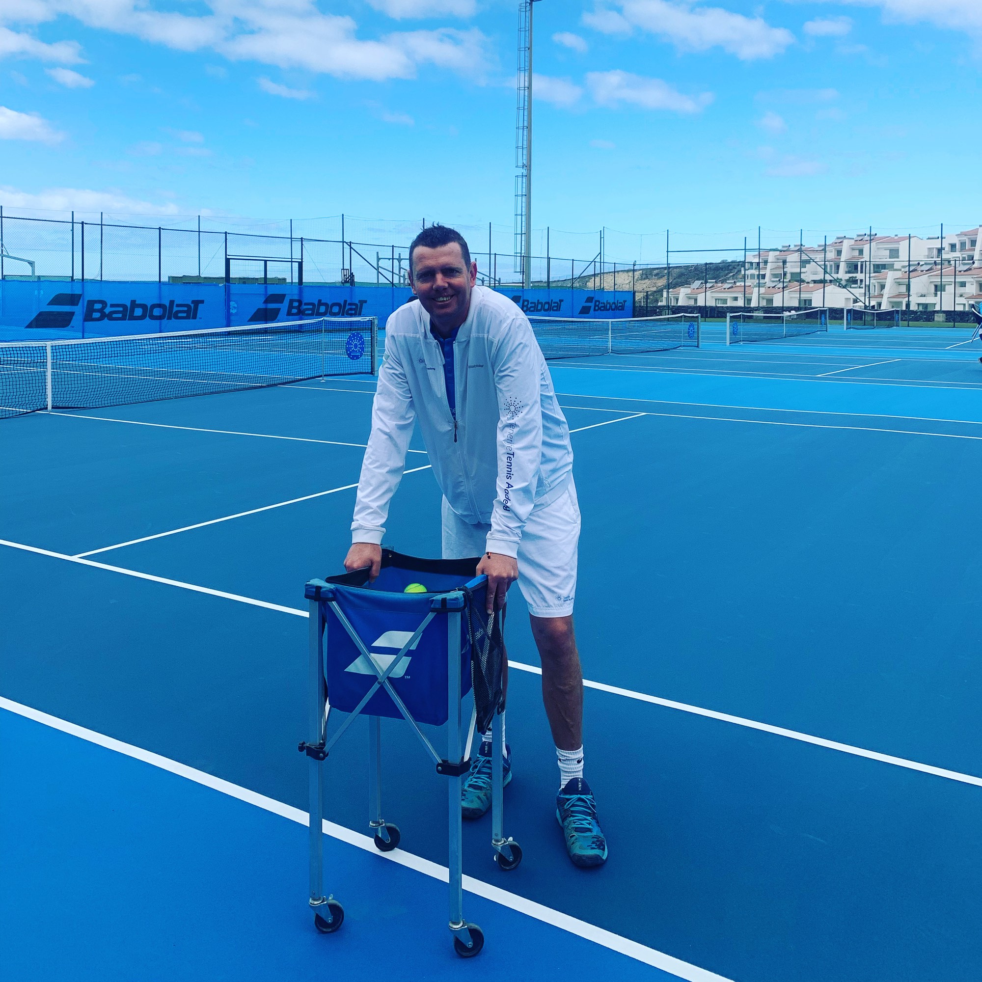 Kris Gray on court in Tenerife with a basket of balls